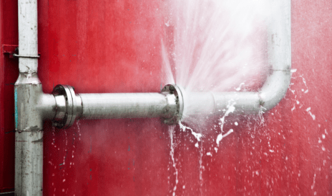 A burst pipe that's spraying water.