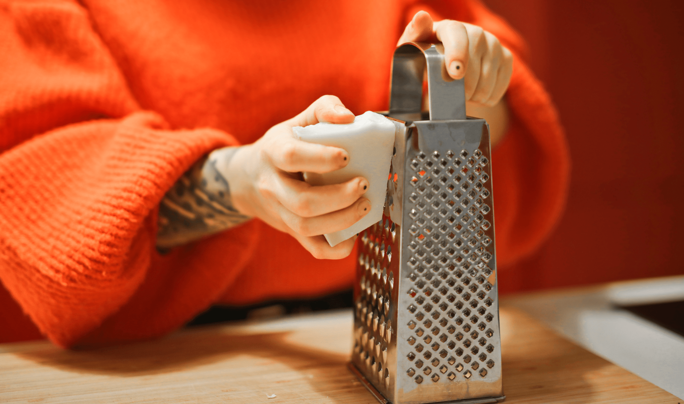 A person grating a bar of soap.
